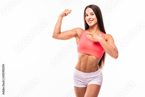Portrait of a beautiful fitness woman showing her biceps isolated on white background