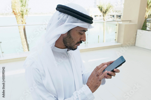 Photography Emirati Arab man on duty wearing traditional Kandura