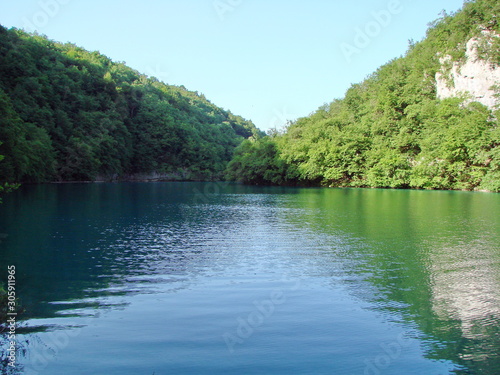 Amazing natural picture of the mirror surface of mountain lakes surrounded by wild, pristine forest.