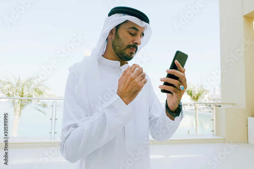 Photography Emirati Arab man on duty wearing traditional Kandura