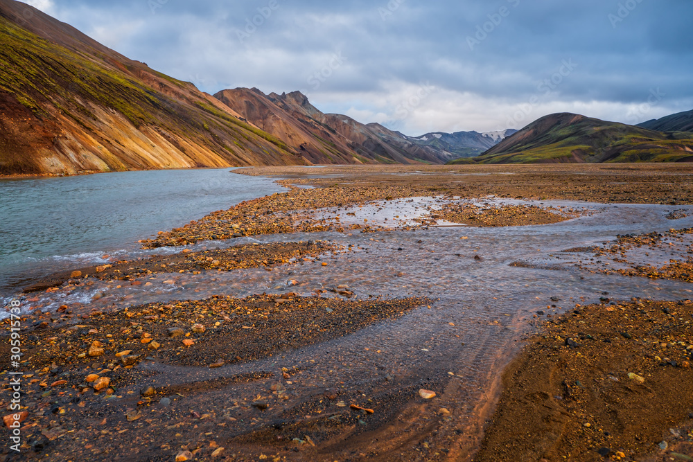 Iceland in september 2019. Great Valley Park Landmannalaugar, surrounded by mountains of rhyolite and unmelted snow. In the valley built large camp. Evening in september 2019