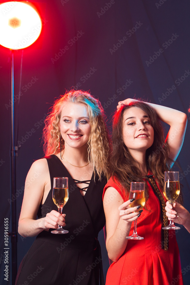 Birthday party, new year and holidays concept - Cheerful female friends celebrating with glasses of champagne, close-up