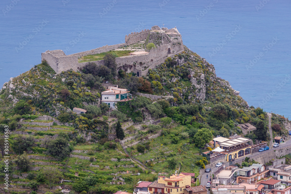 Obraz premium Ruins of Saracen castle on a top of the rock in Taormina city - viewm from Castelmola, small town on Sicily Island, Italy