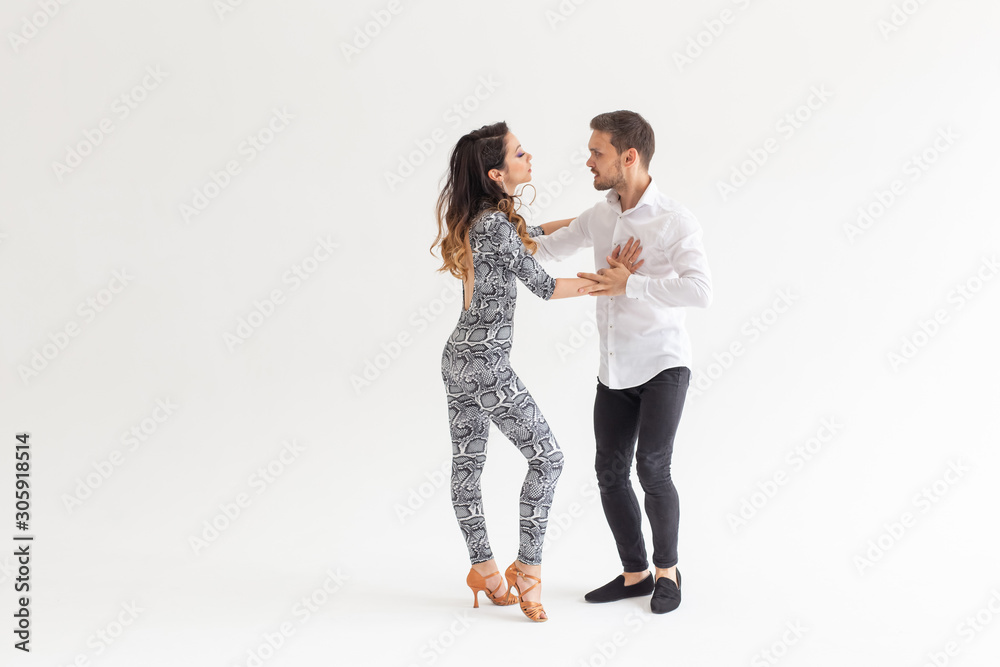 Social dance concept - Active happy adults dancing bachata together over white background with copy space Social dance concept - Active happy adults dancing bachata together over white background with copy space