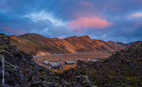 Iceland in september 2019. Great Valley Park Landmannalaugar, surrounded by mountains of rhyolite and unmelted snow. In the valley built large camp. Evening in september 2019 photo