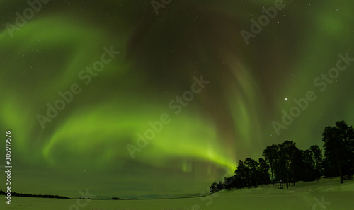 Northern lights in Inari lake, Lapland, Finland