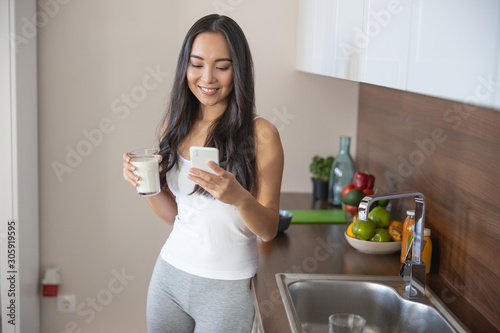 Lovely smiling young woman surfing the net