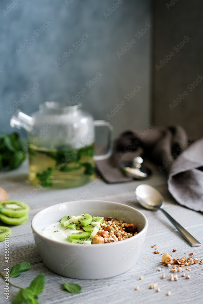 Buckwheat granola with yogurt and kiwi. Nutritious healthy breakfast