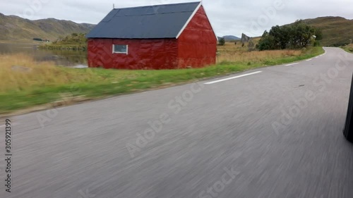 Driving around Lofoten pasta red house in a white van. photo