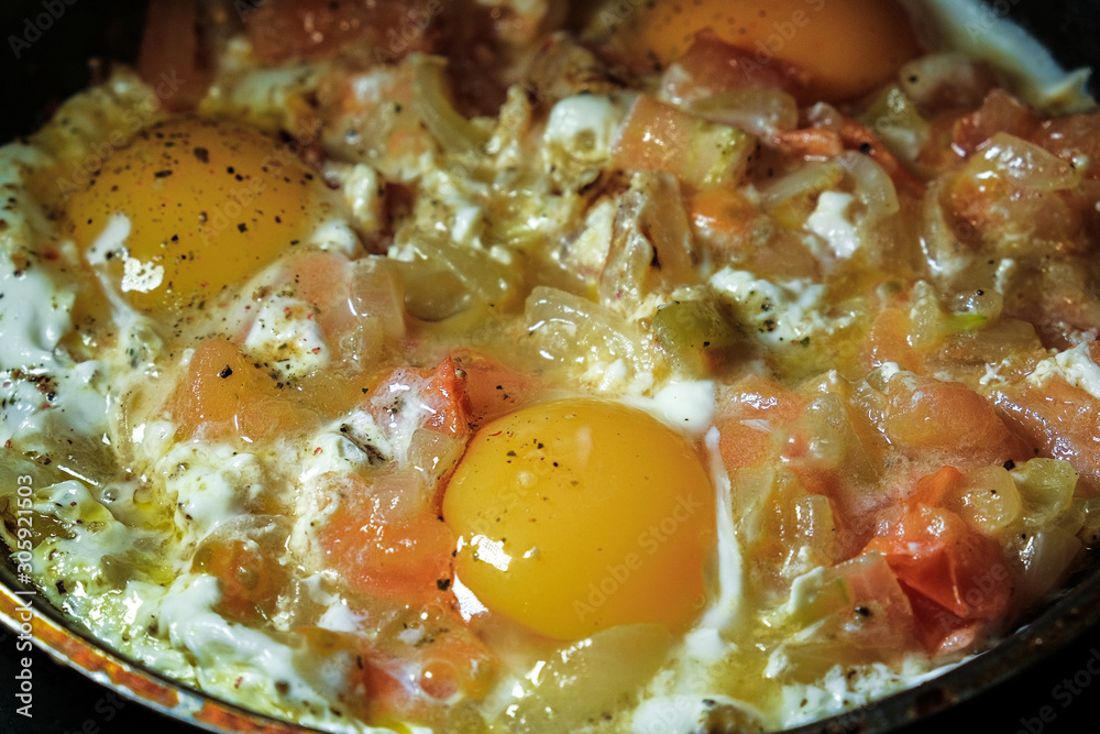 the fresh eggs and potatoes are fried in a pan the fresh eggs and potatoes are fried in a pan