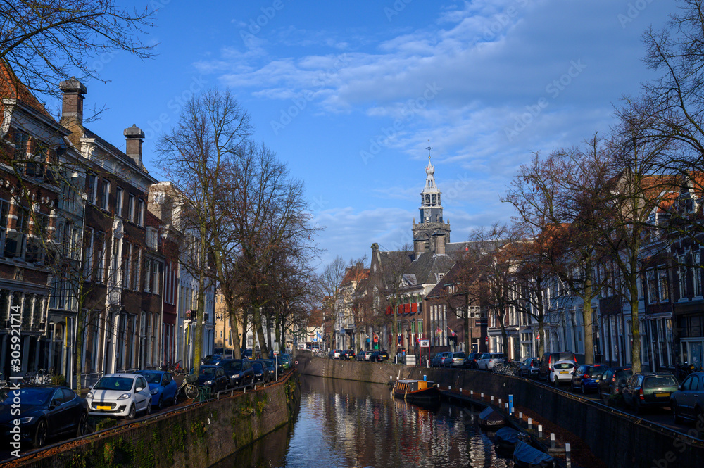 Canal in Gouda, the Netherlands (Europe), overlooking the tower of the Sint Janskerk.
