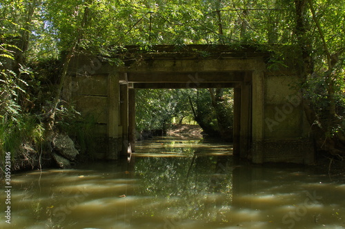 Bridge over the water channel in Park Marais Poitevin near Maillezais in France Europe