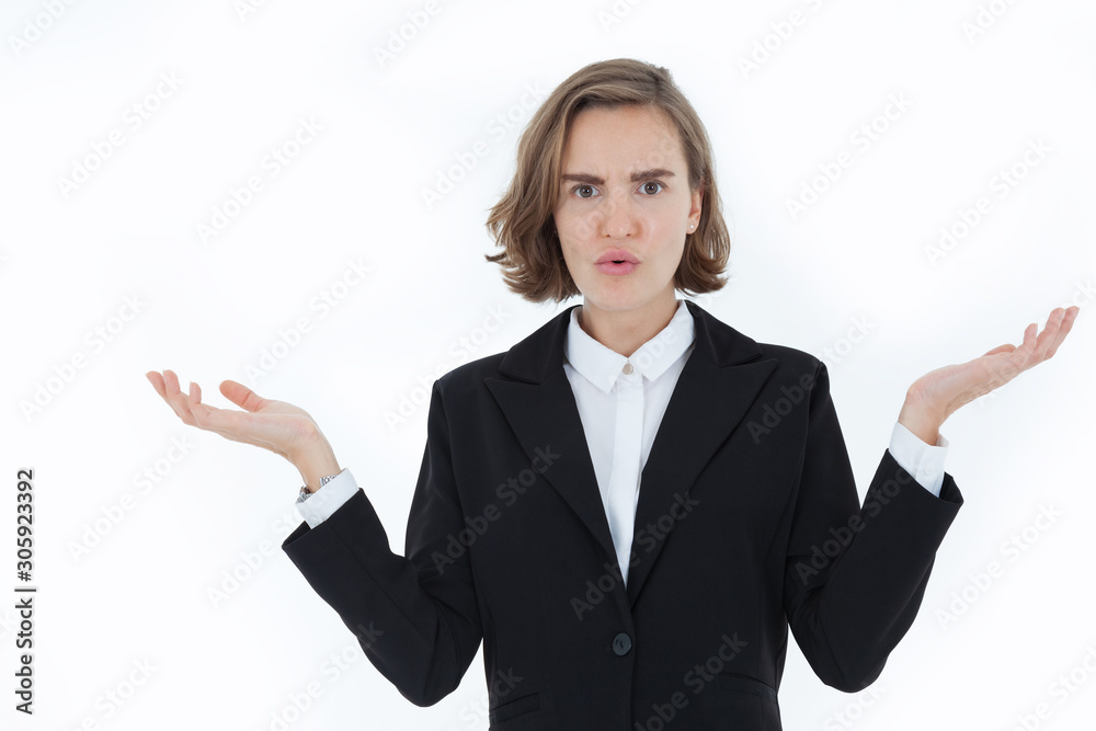 A beautiful business woman wearing a suit is disgruntled and angry, with both hands raised against the white background in the concept of business Bad news. Trade war. Slow down of world economic. A beautiful business woman wearing a suit is disgruntled and angry, with both hands raised against the white background in the concept of business Bad news. Trade war. Slow down of world economic.