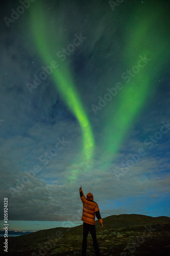 Northern lights and man in Nordkapp, Norway