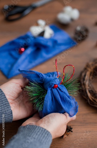 Christmas furoshiki wrapping. Etnical hristmas gift. Zero waste concept © Jane_S