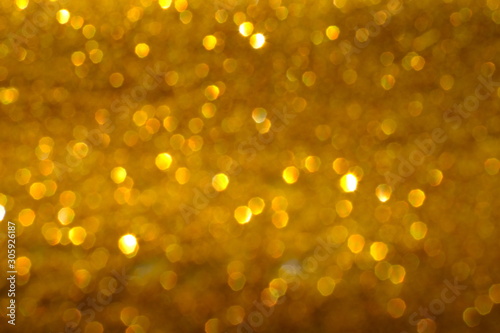 Blurry abstract golden background with bokeh lights