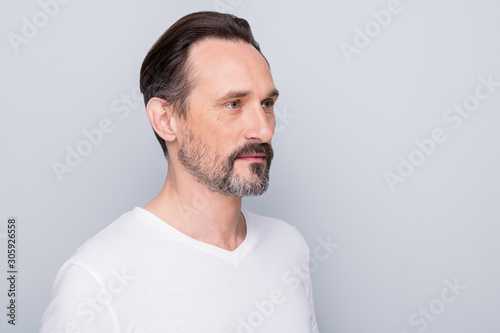 Closeup profile photo of handsome aged man seriously looking side empty space see mirror new wrinkles going to apply anti age cream wear white t-shirt isolated grey color background