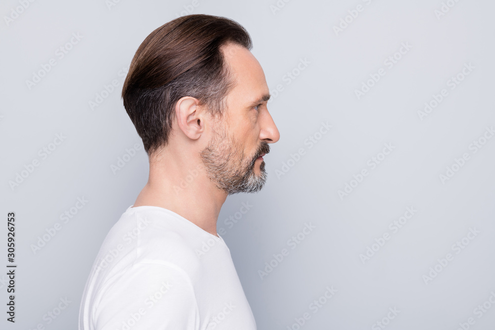 Closeup profile photo of handsome aged man seriously looking side empty space mature wrinkles think about anti age cream wear white t-shirt isolated grey color background Closeup profile photo of handsome aged man seriously looking side empty space mature wrinkles think about anti age cream wear white t-shirt isolated grey color background