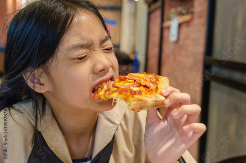 Asian children eat pizza
