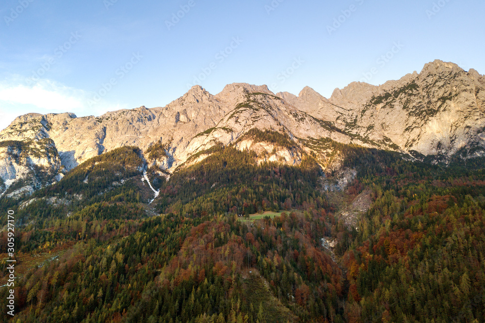 Aerial view of majestic european Alps mountains covered in evergreen pine forest in autumn. Aerial view of majestic european Alps mountains covered in evergreen pine forest in autumn.