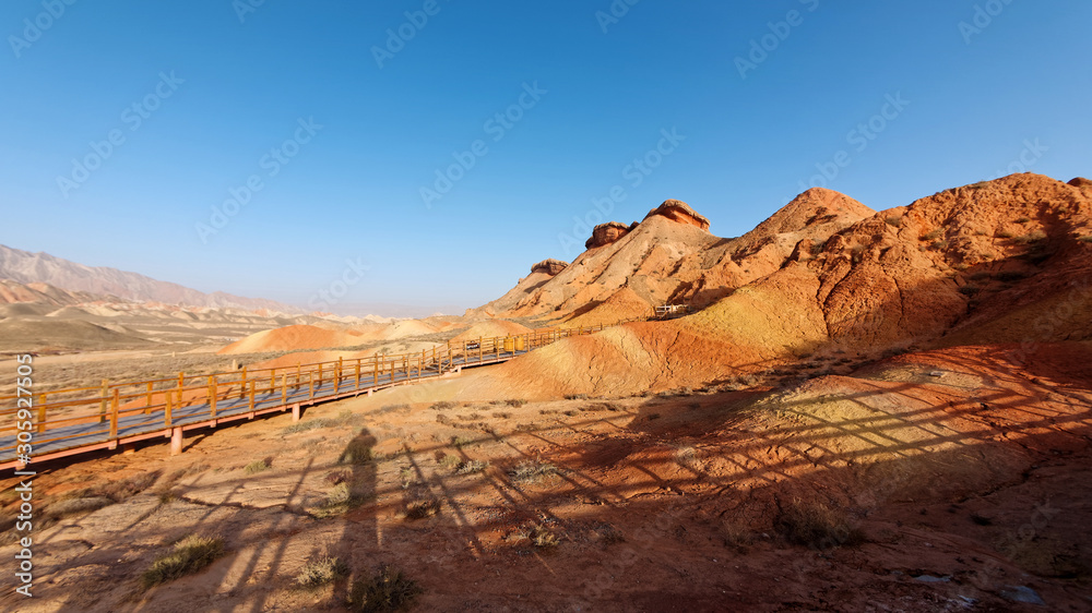 Fototapeta premium Amazing scenery of Rainbow mountain and blue sky background. Zhangye Danxia National Geopark, Gansu, China. Colorful landscape, rainbow hills, unusual colored rocks, sandstone erosion.