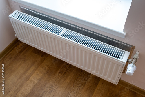 Wallpaper Mural White metal heating radiator mounted on a wall in room interior. Torontodigital.ca