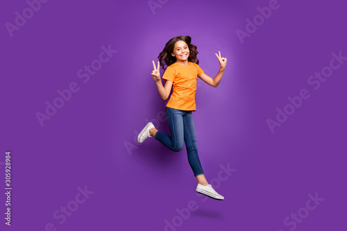 Full length body size view of her she nice attractive lovely charming cheerful cheery wavy-haired girl jumping showing v-sign isolated over lilac purple violet pastel color background