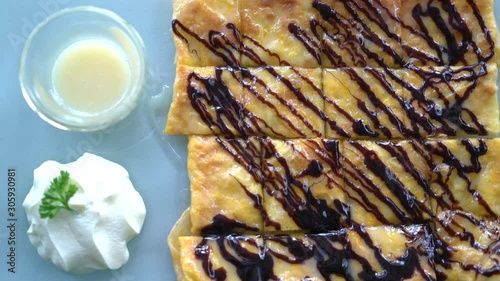 roti with chocolate sauce on plate photo