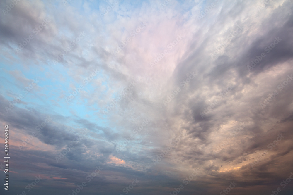 Naklejka premium Sunset sky covered with orange puffy clouds in the evening.
