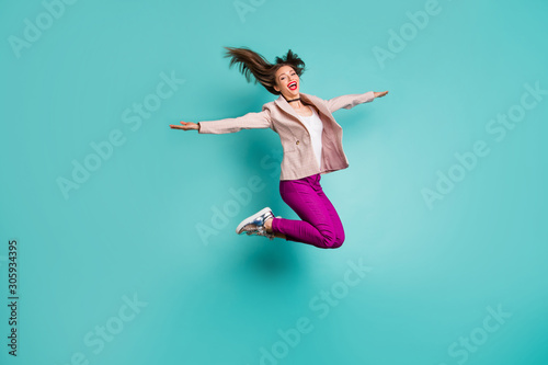 Full length body size view of her she nice attractive careless cheerful cheery girl jumping having fun fooling flying isolated on bright vivid shine vibrant blue green turquoise color background