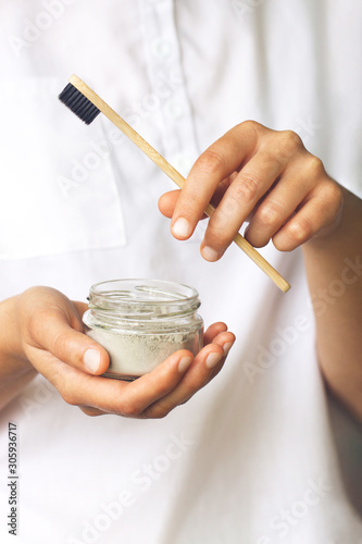 Set of eco-friendly tooth care items in woman's hands. Zero waste concept, plastic-free, organic, eco-friendly shopping