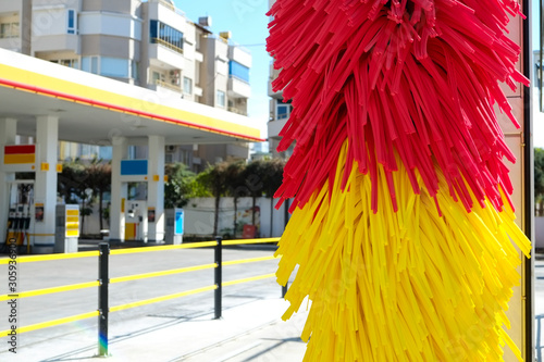 Fototapeta Naklejka Na Ścianę i Meble -  Empty outdoor self service car wash at gas station premises. Colorful red and yellow rotating carwash brushes. Close up, copy space, background.