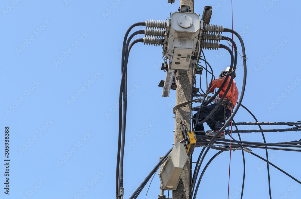Electricians are climbing on electric poles to install and repair power lines. Electricians are climbing on electric poles to install and repair power lines.