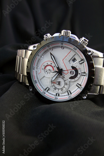 Men's wrist metal watch on black background