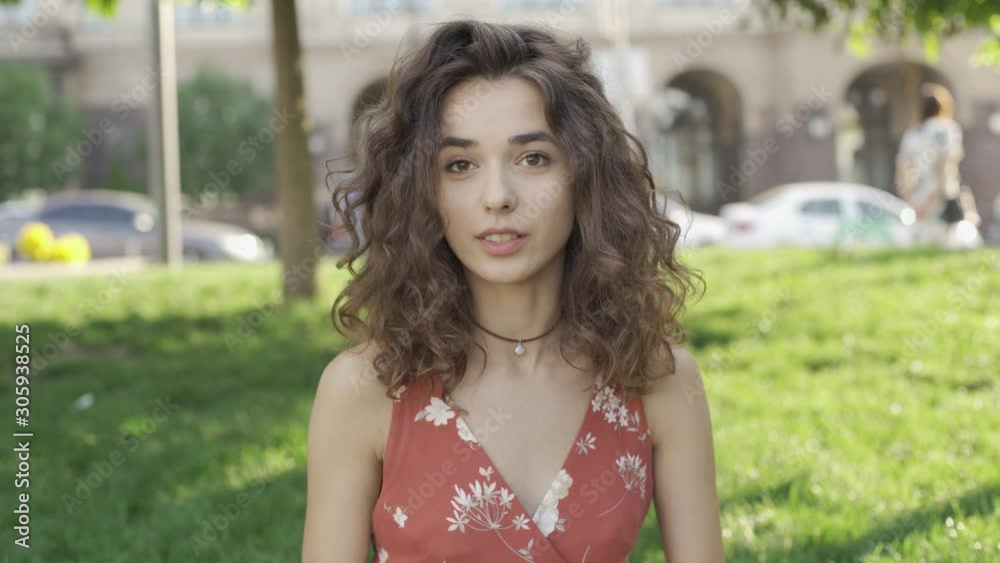 Beautiful brunette with curly hair eats a delicious burger Beautiful brunette with curly hair eats a delicious burger
