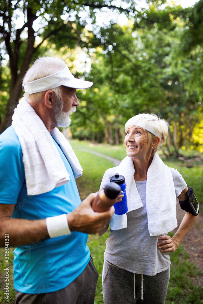 Fitness, sport, people, exercising and lifestyle concept - senior couple running