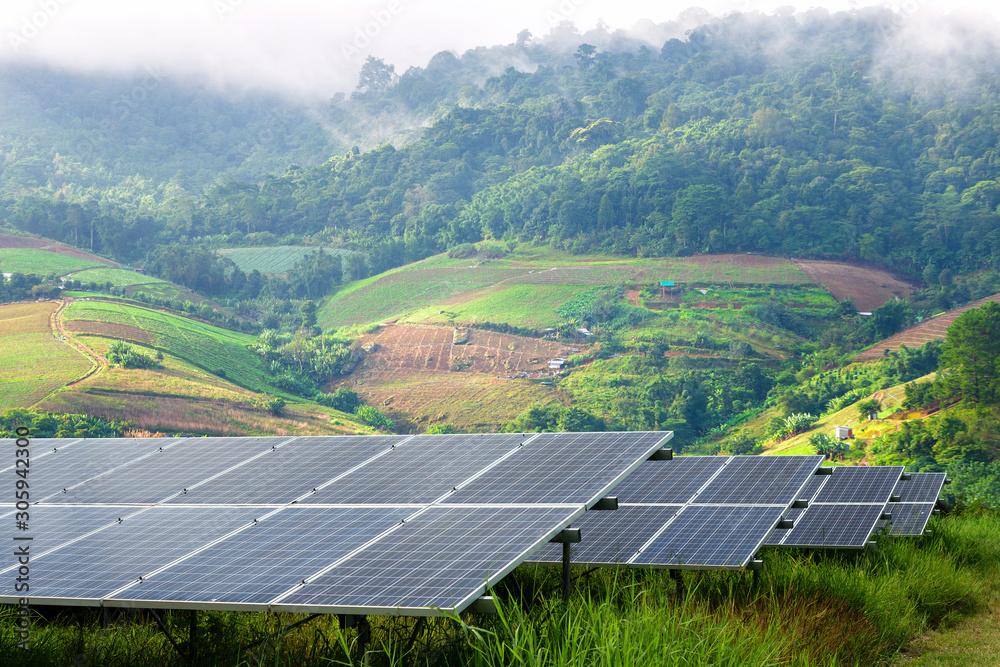 power solar panel on little mountainous village and the mist are beauty on view point background,alternative clean green energy concept