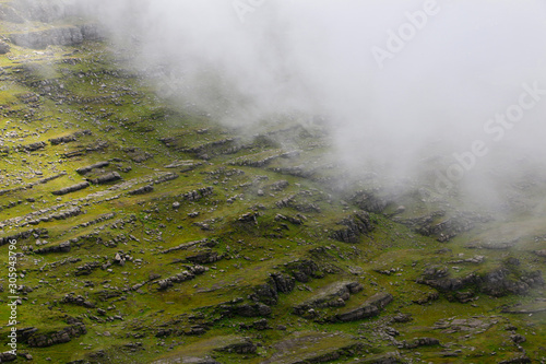 A green meandow with rocks in the Swiss alps photo