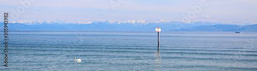 Lake Constance with a swan, a boat and a sign photo