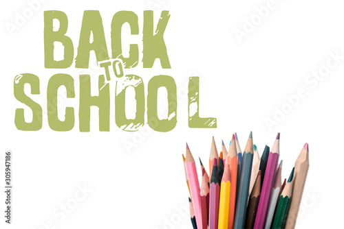 multicolored pencils near back to school letters on white