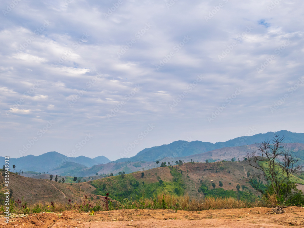 Hot and dry agriculture, bald mountains from shifting cultivation were created by poor hill tribes in Nan, causing global warming and major flooding in northern Thailand.