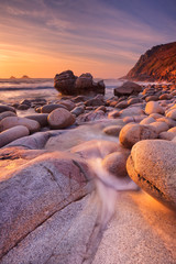 Leinwandbilder Lavendelfarbene Motive Rocky beach at sunset, Porth Nanven, Cornwall, England  © sara_winter