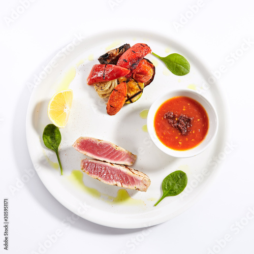 Tuna steak with grilled vegetables top view