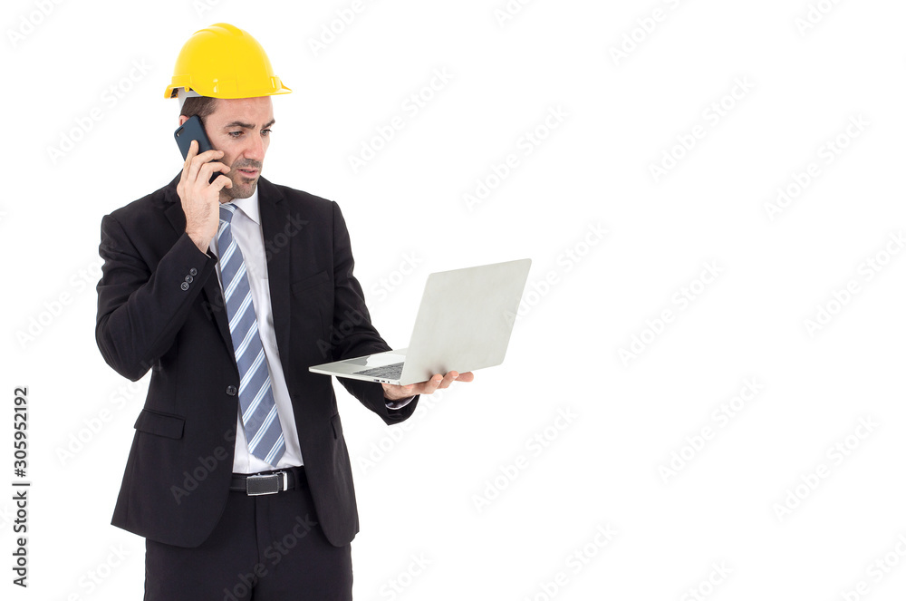 Architect holding a laptop talking on the phone with copy space Architect holding a laptop talking on the phone with copy space