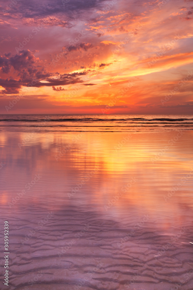 Sunset reflections on the beach, Texel island, The Netherlands
