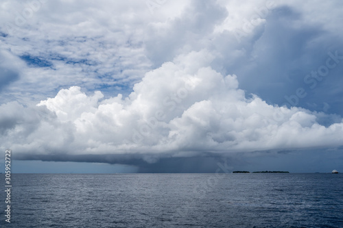 Large severe thunderstorm storm cloud forms over the Maldives on the Indian Ocean