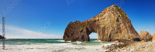 Natural arch on the rocky coastline of Izu Peninsula, Japan photo