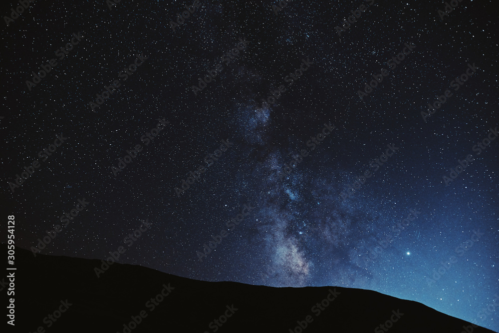 Astrophotography. Milky way with mountains silhouette