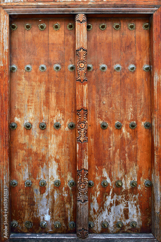 Traditional wooden carved door in Stone Town, Zanzibar, Tanzania, Africa