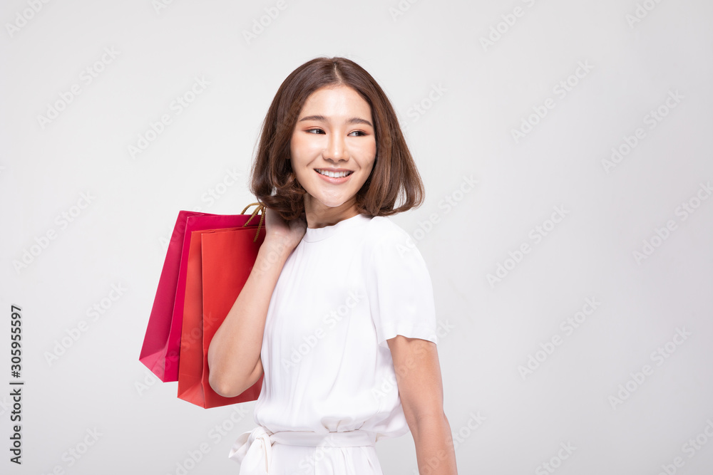 Shopping Asian woman with short hairs smile and Holding Shopping bags, Cheerful and happiness emotional, Enjoy Shopping in black friday sale, Isolated on gray background, Shopping Concept Shopping Asian woman with short hairs smile and Holding Shopping bags, Cheerful and happiness emotional, Enjoy Shopping in black friday sale, Isolated on gray background, Shopping Concept
